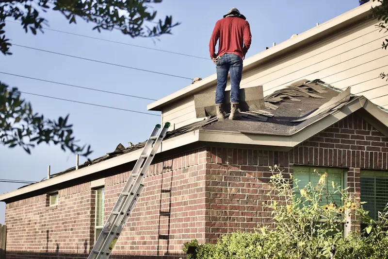 Professional roofer working on a residential roof in Lake in the Hills